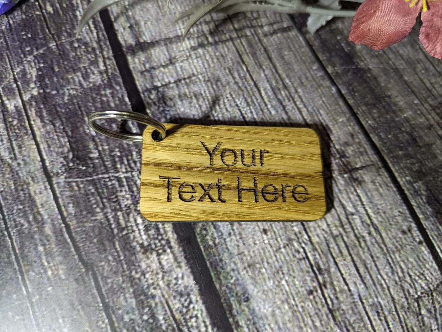 Double-sided oak keyring 65x35mm — reverse showing smooth veneer, split ring
