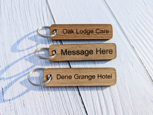 Personalised oak wooden keyrings — engraved with room name or custom text, 80x20mm