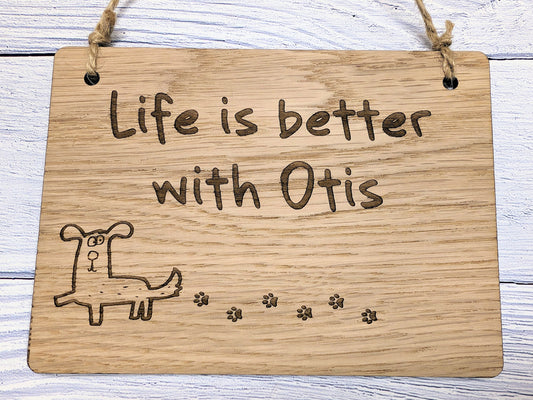 Personalised dog name sign showing engraved text detail, oak veneer finish, small size