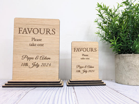 Favours Please Take One sign close-up of engraved couple's names and date