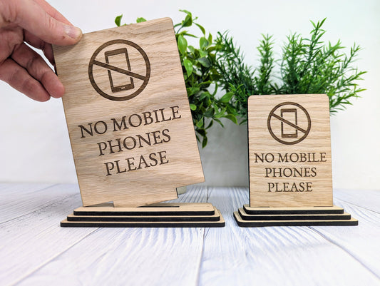 No Mobile Phones freestanding sign close-up of engraved text