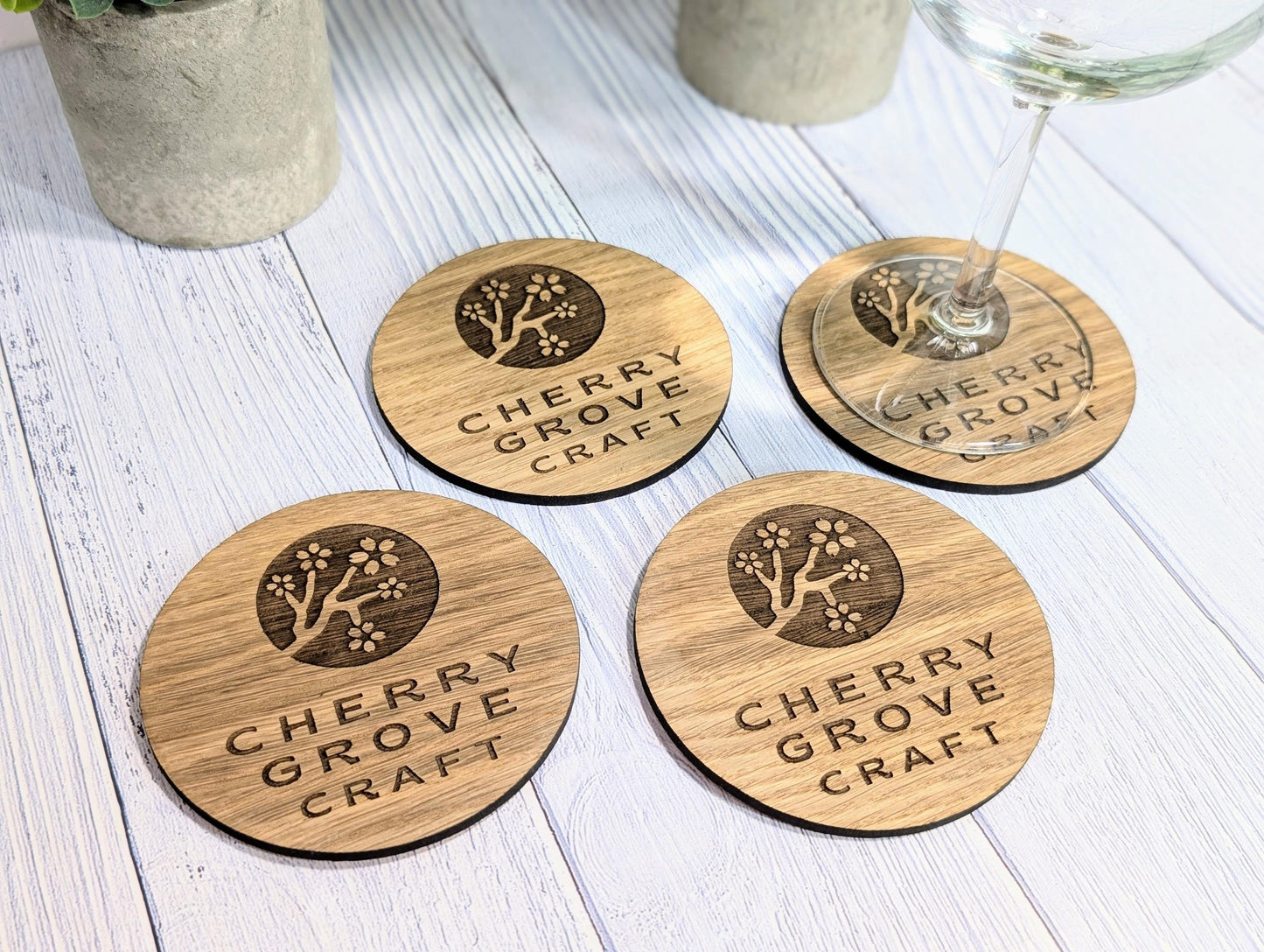 Branded oak coasters stacked — bulk order 20 units, 100mm round