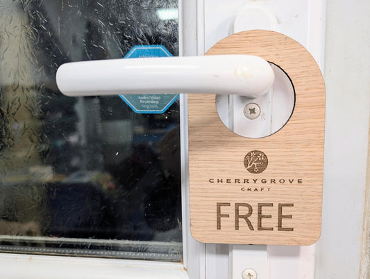 In Use / Free logo door hanger — In Use side, laser engraved oak veneer