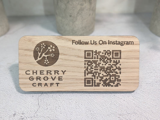 Front of the Instagram QR code stand in oak, 150 × 70mm, engraved with a logo, "Follow Us On Instagram" and a QR code