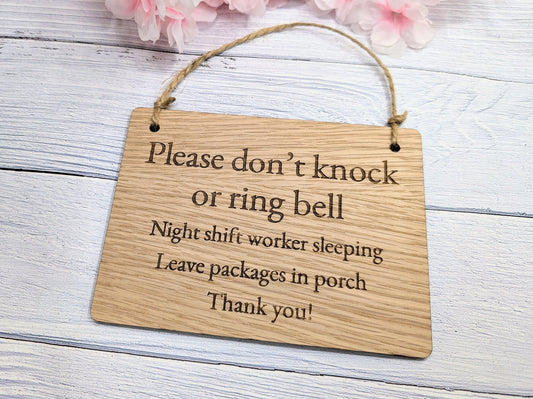 Bamboo night shift sign close-up — engraved message, natural grain