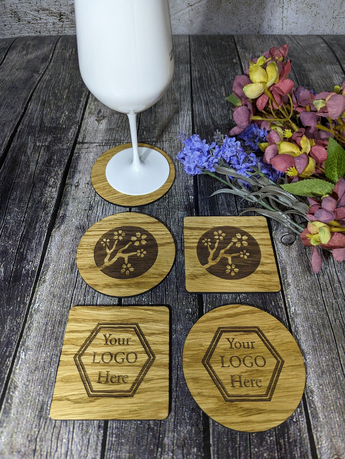 Oak coasters laser engraved with a business logo, round and square, as a client Christmas gift
