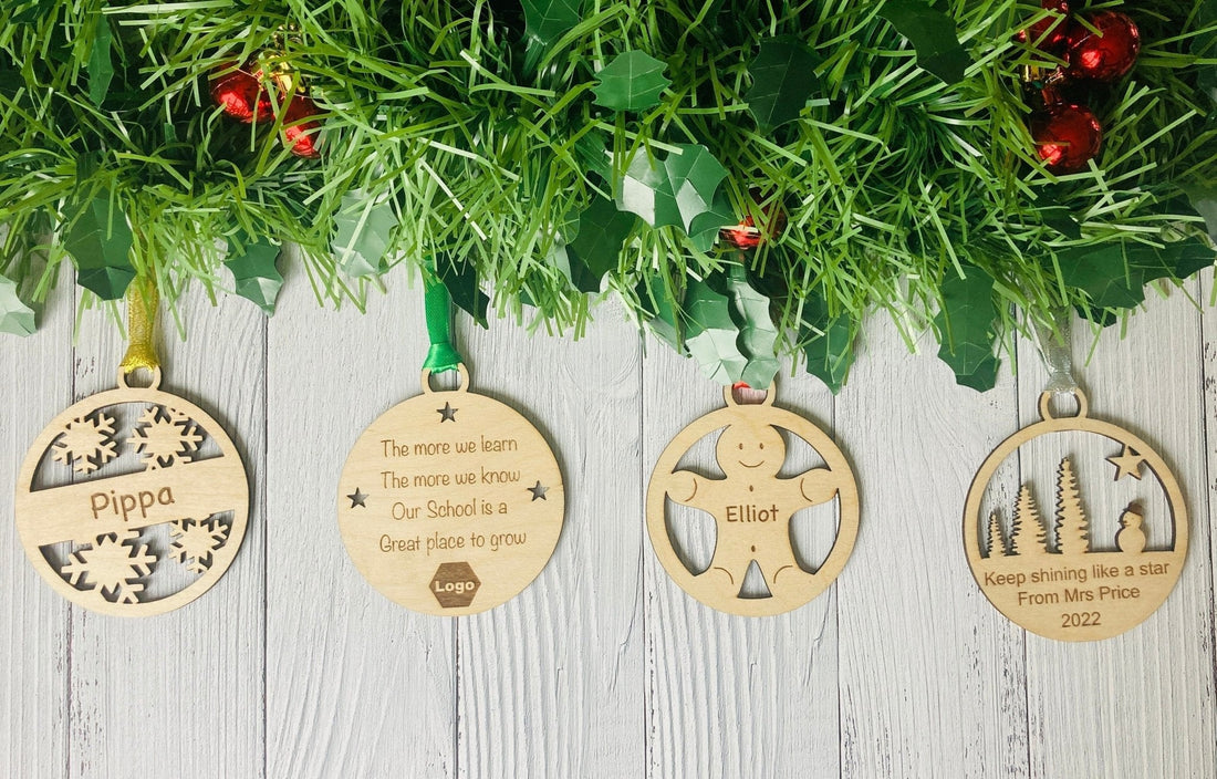 Personalised oak Christmas baubles for a class of pupils, each 100mm and engraved with a child's name