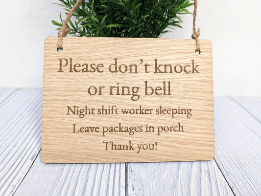 Hanging wooden door sign reading Please don't knock or ring bell, night shift worker sleeping, leave packages in porch