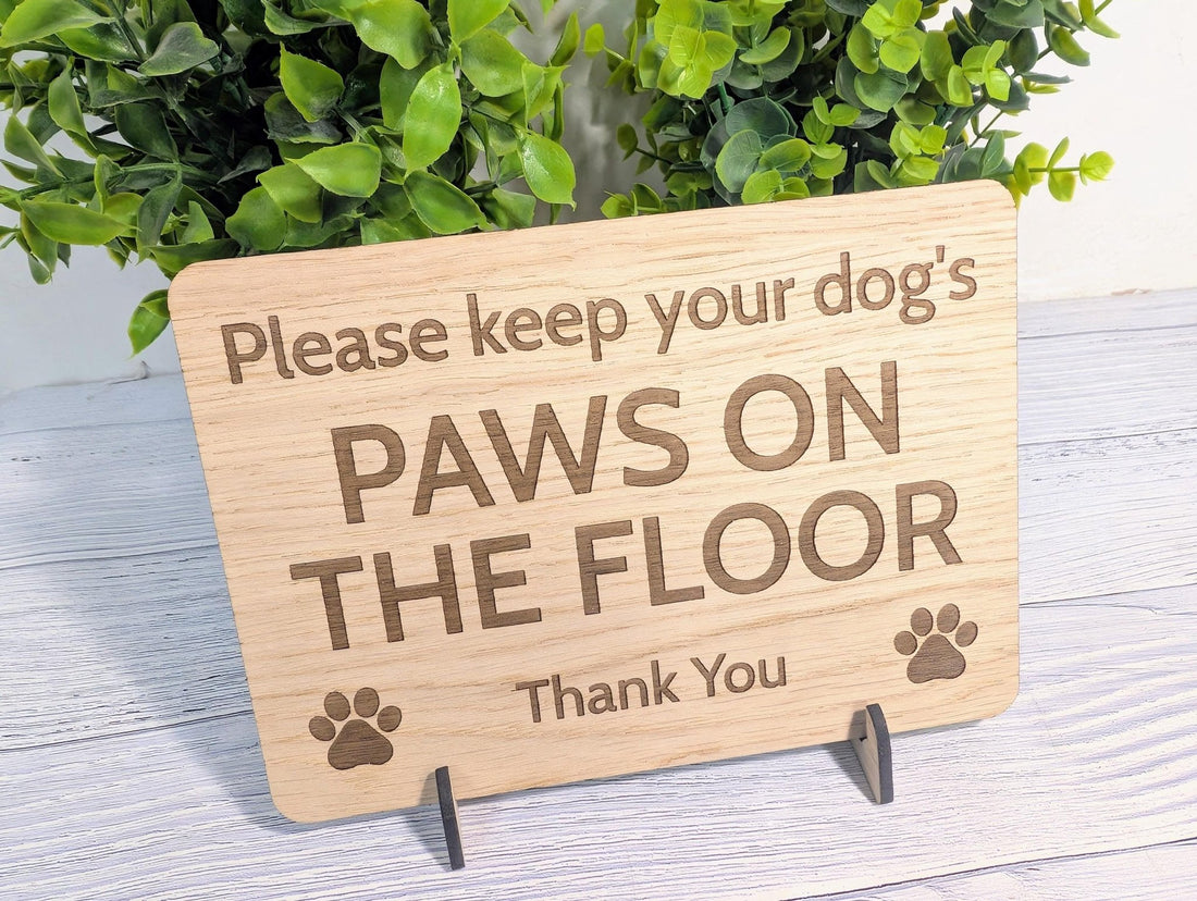Keep Dog's Paws on Floor sign detail showing engraved text and paw print, oak veneer finish
