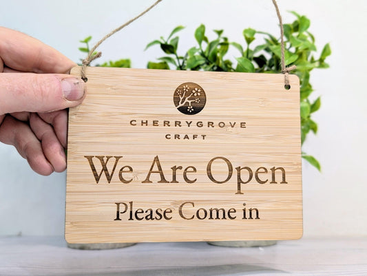 We Are Open sign laser engraved on FSC-certified Moso bamboo