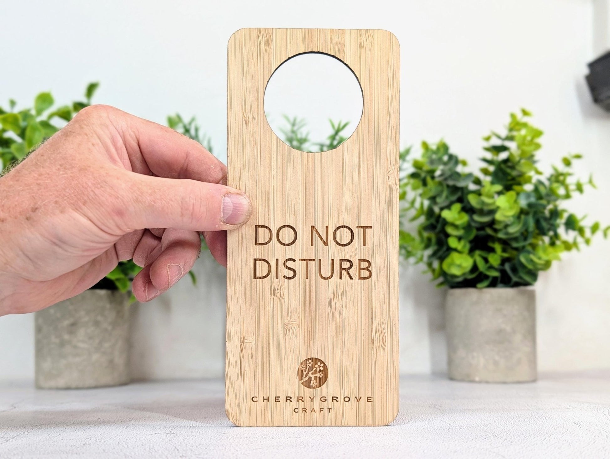 5mm bamboo door hanger engraved with Do Not Disturb text, potted plants background