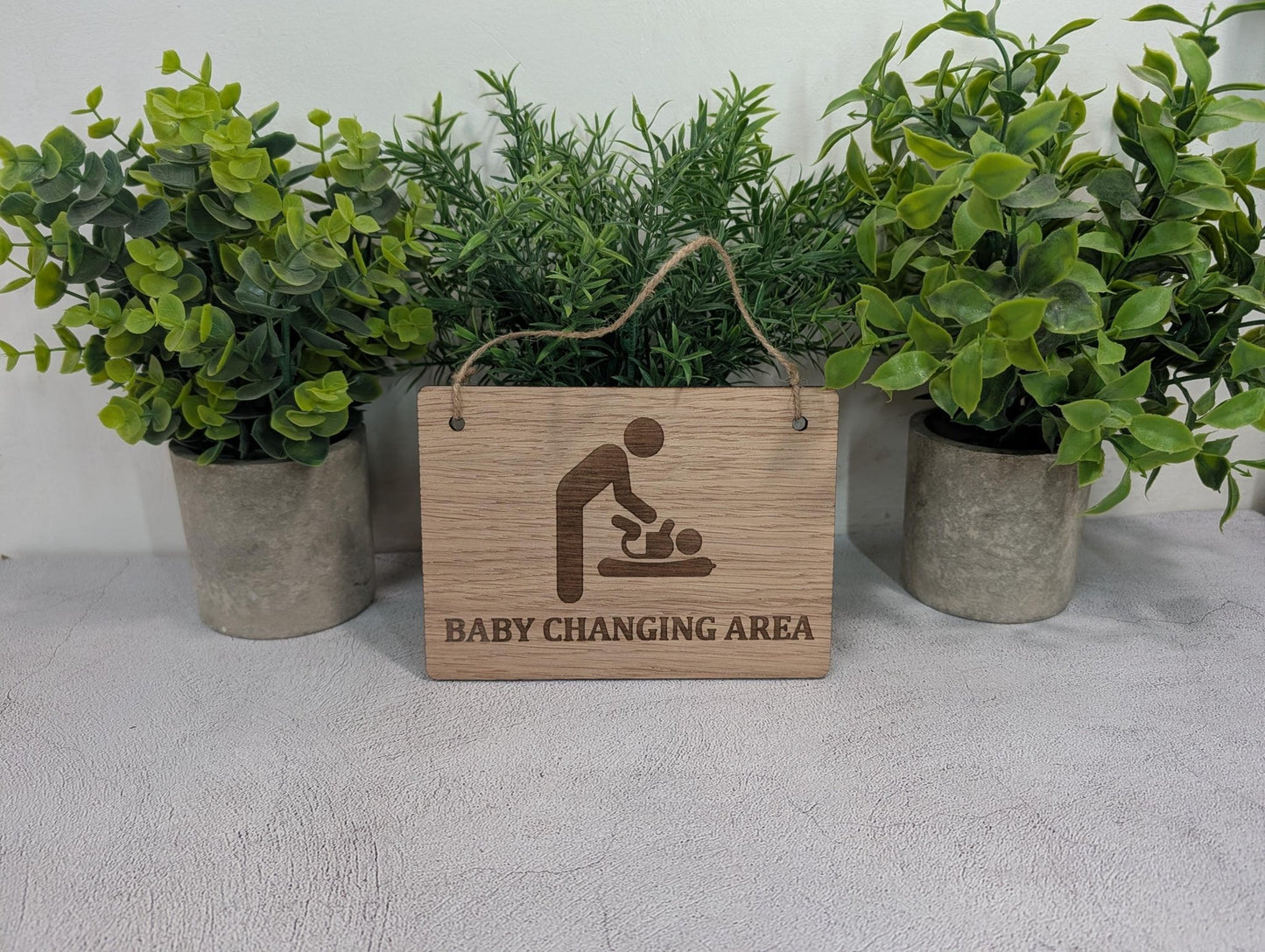 Baby changing area sign — all four sizes Small to Extra Large on white background