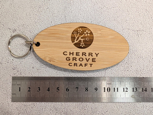 5mm bamboo oval keyring, 100 by 50mm, on textured stone surface