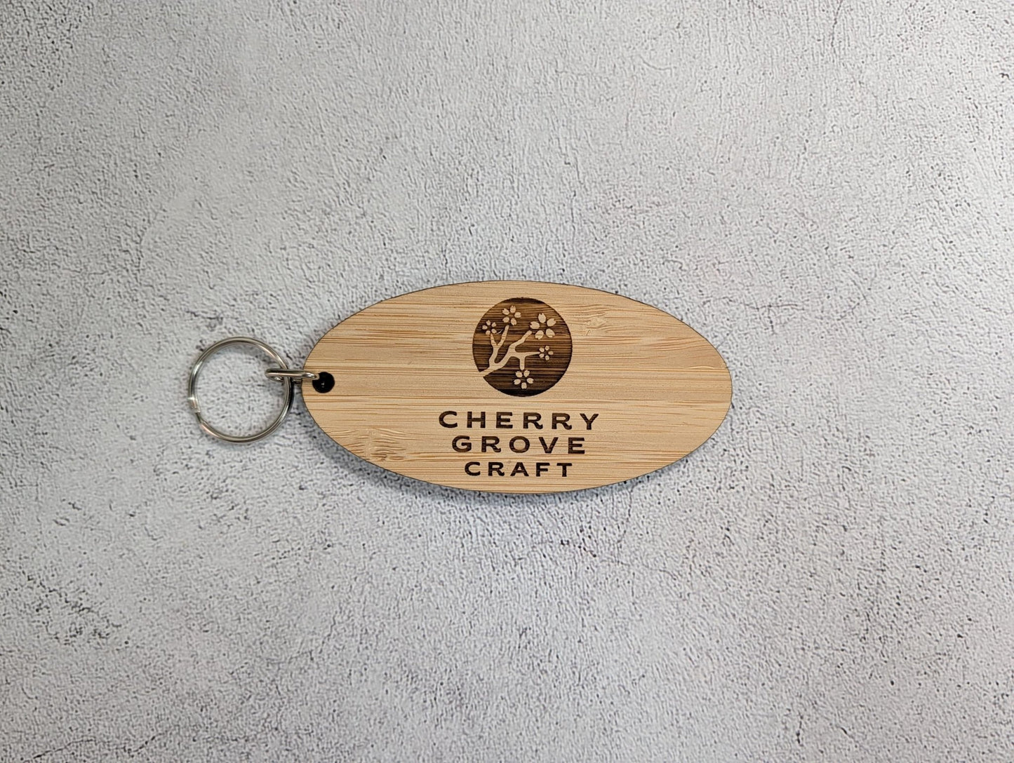 5mm premium bamboo oval business keyring, 100 by 50mm, laser-engraved with a custom logo