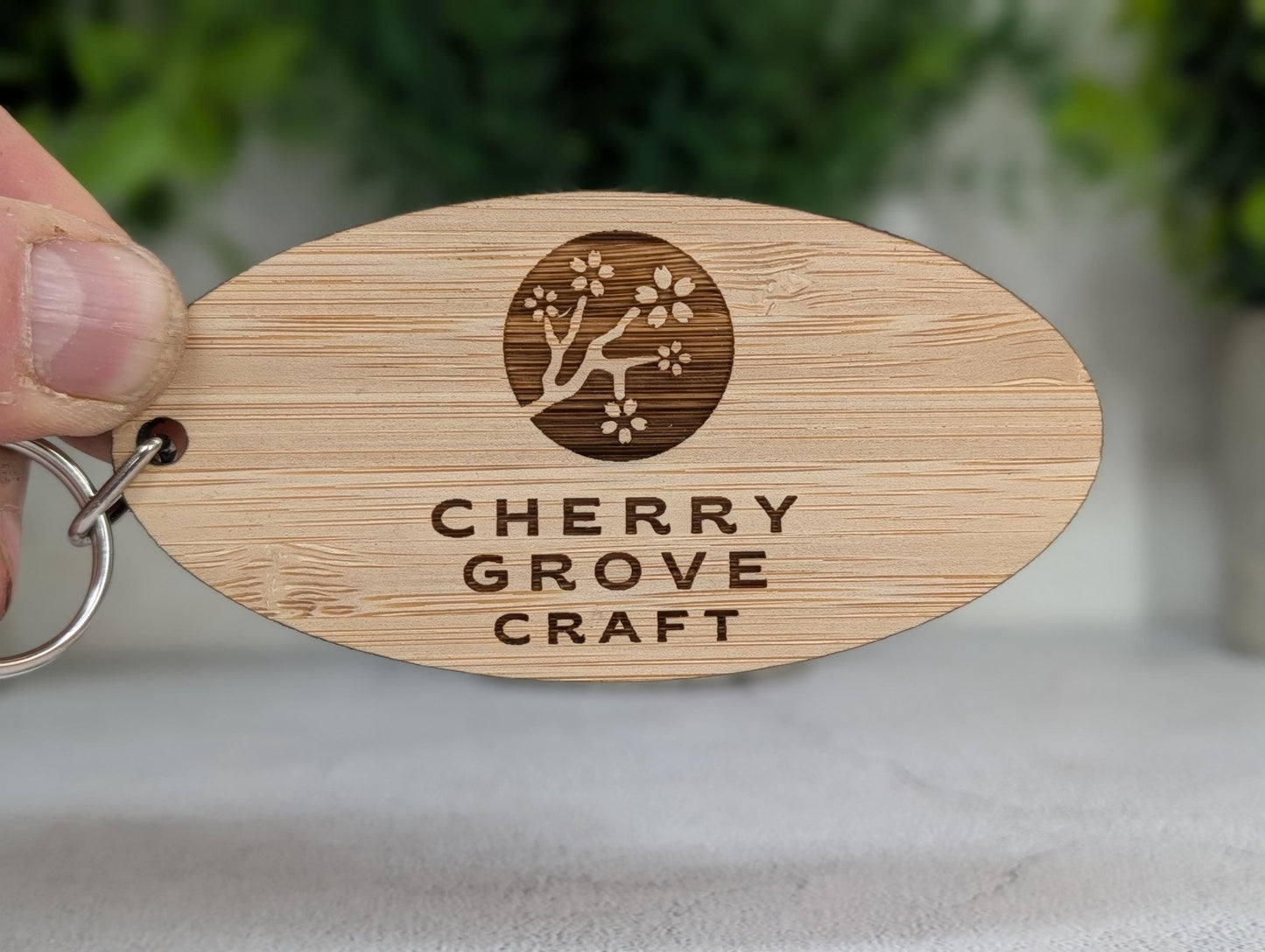 Double-sided 5mm bamboo business keyring showing reverse engraving and metal split ring