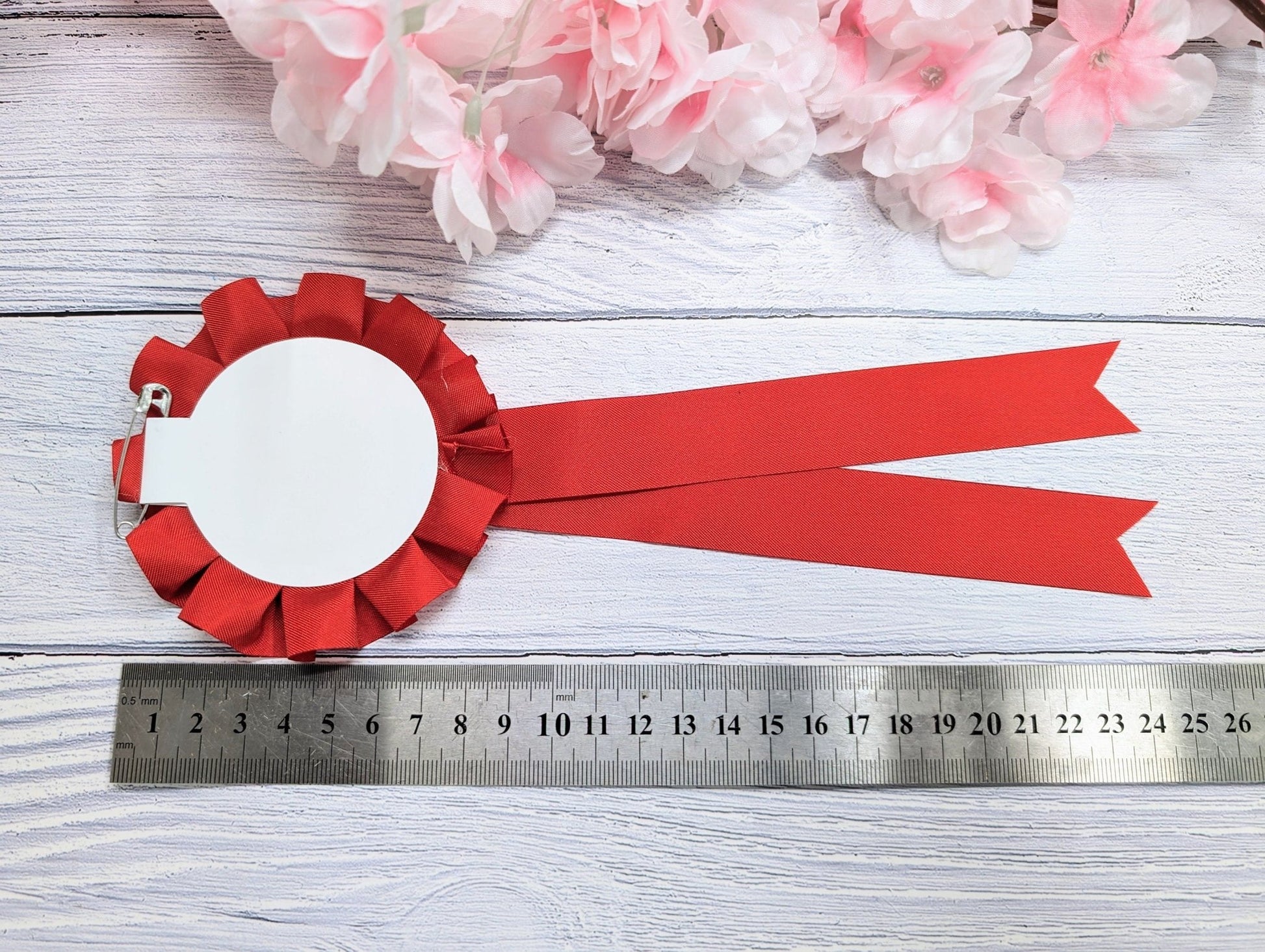 Best and Worst Christmas Jumper rosette in blue — 90mm, pin back