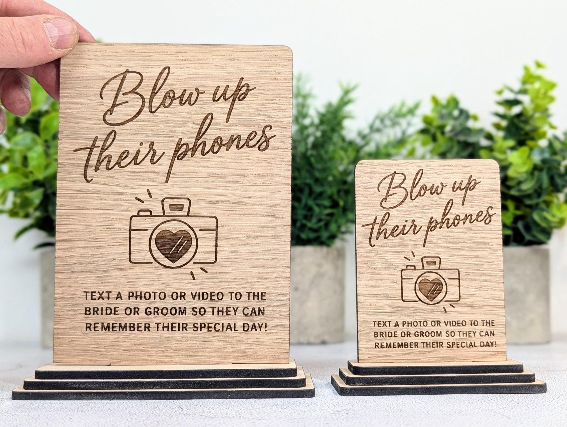 Blow Up Their Phones wedding table sign in oak veneer, freestanding on a layered oak base