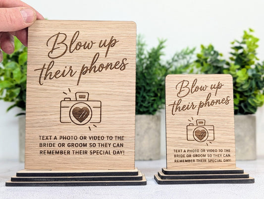 Blow Up Their Phones wedding table sign in oak veneer, freestanding on a layered oak base
