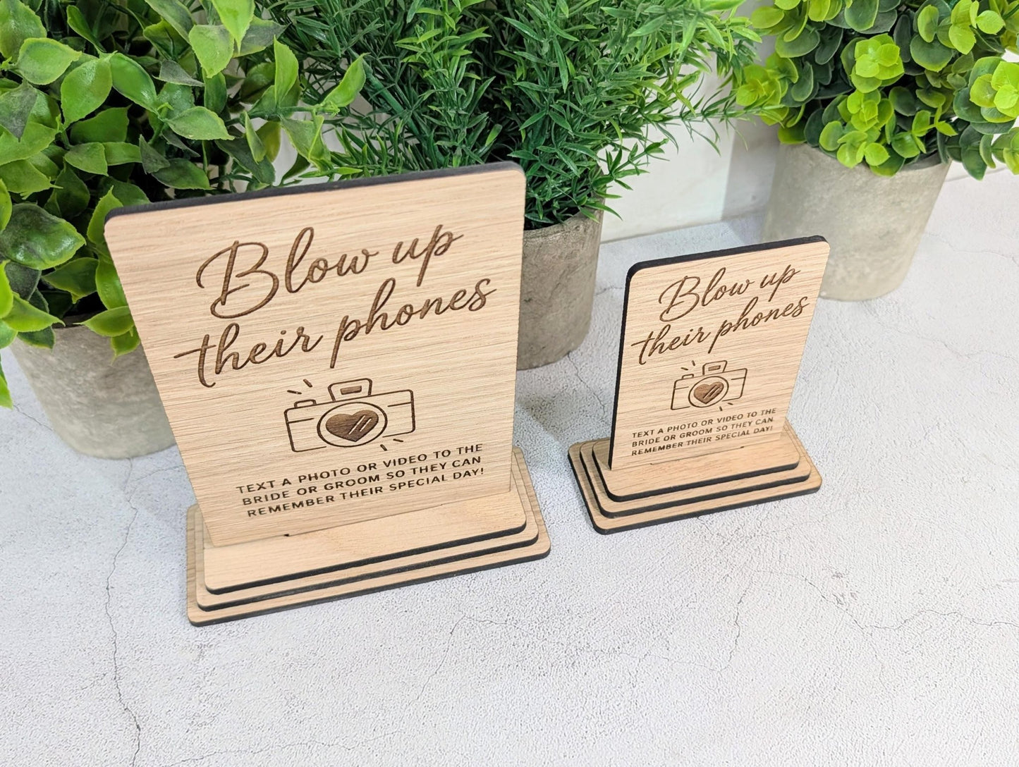 Freestanding oak wedding sign on a reception table