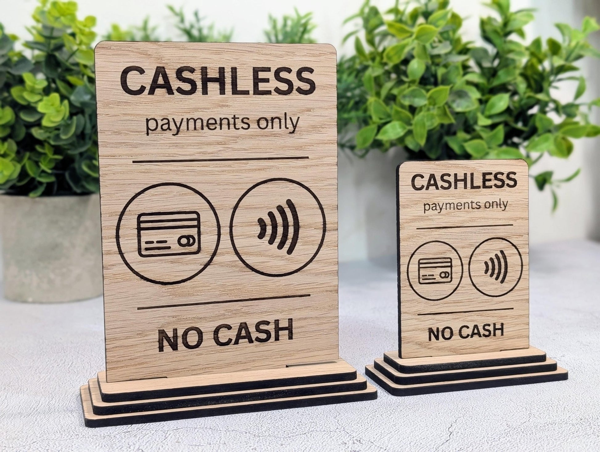 Cashless payments only sign close-up — laser-engraved wording on oak veneered MDF