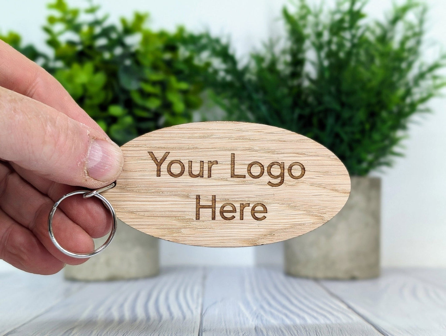 Double-sided 100x50mm oak keyring — showing bulk order for company