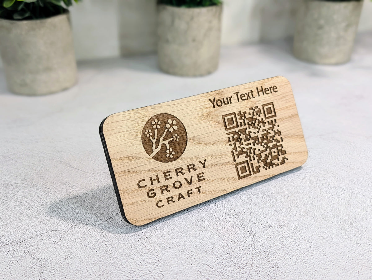 Custom QR code stand seen at an angle, showing the engraved logo, text line and QR code on the 8mm oak panel