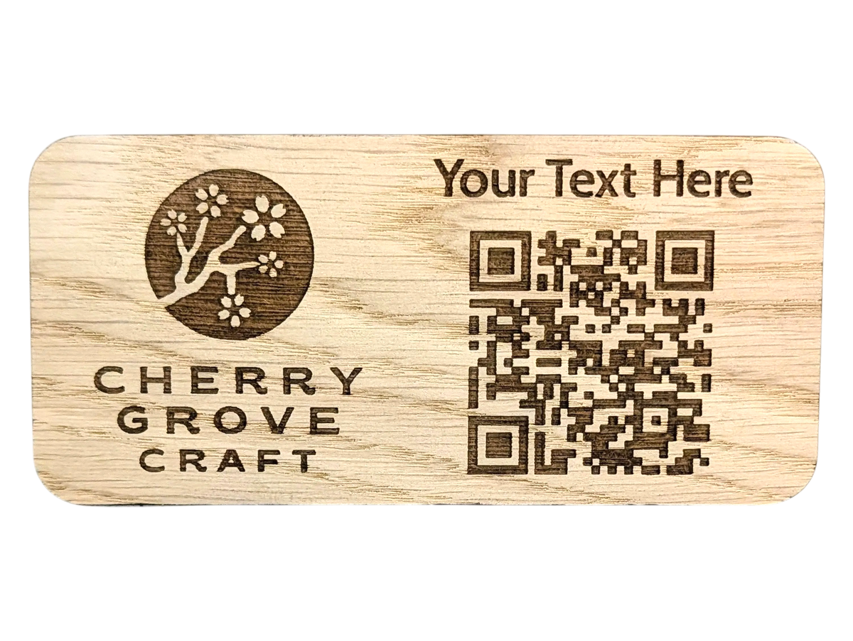 Front of the custom QR code stand in oak, 150 × 70mm, engraved with a logo, a line of custom text and a QR code