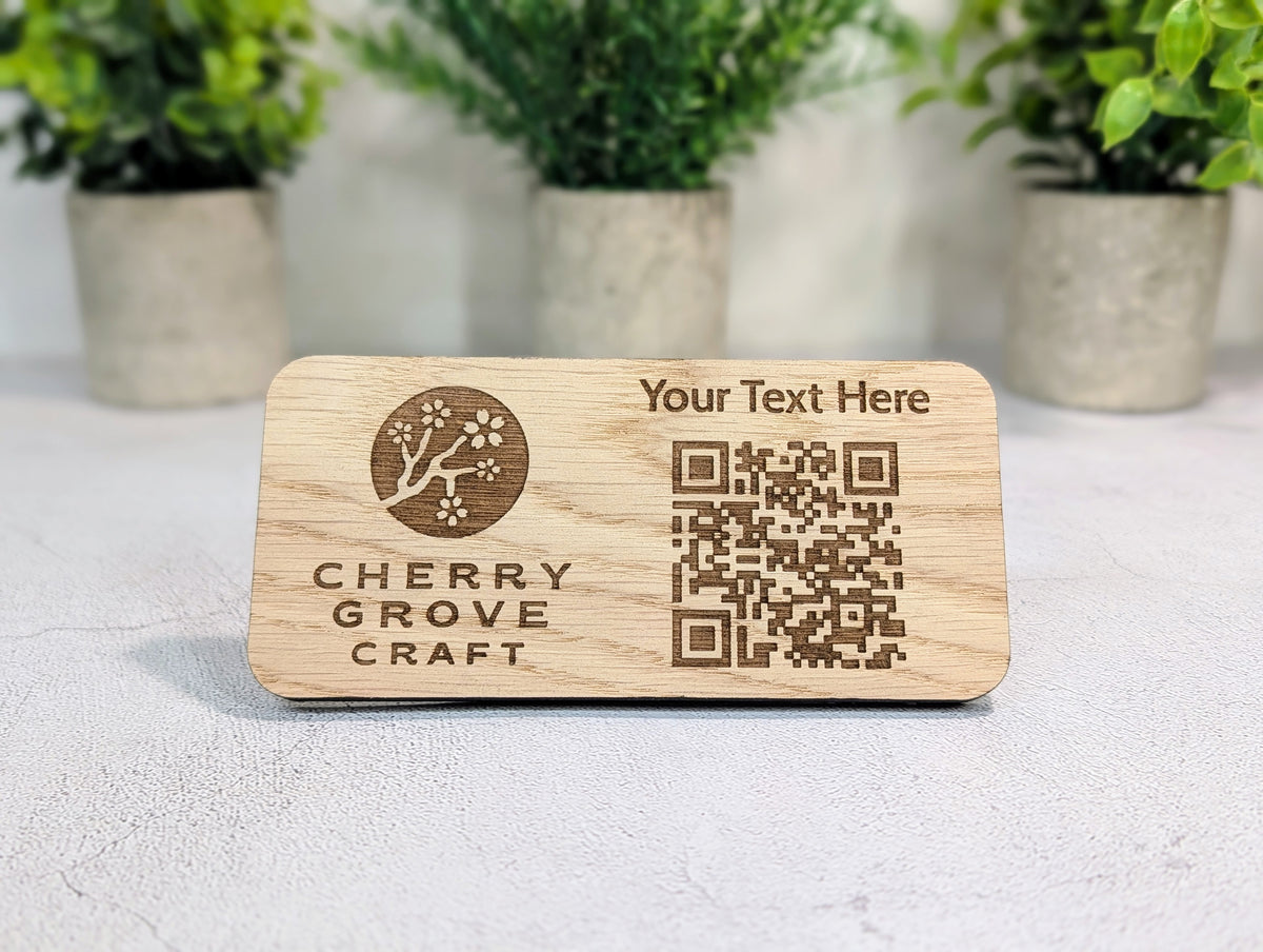 Oak custom QR code stand standing on a table in front of three potted plants