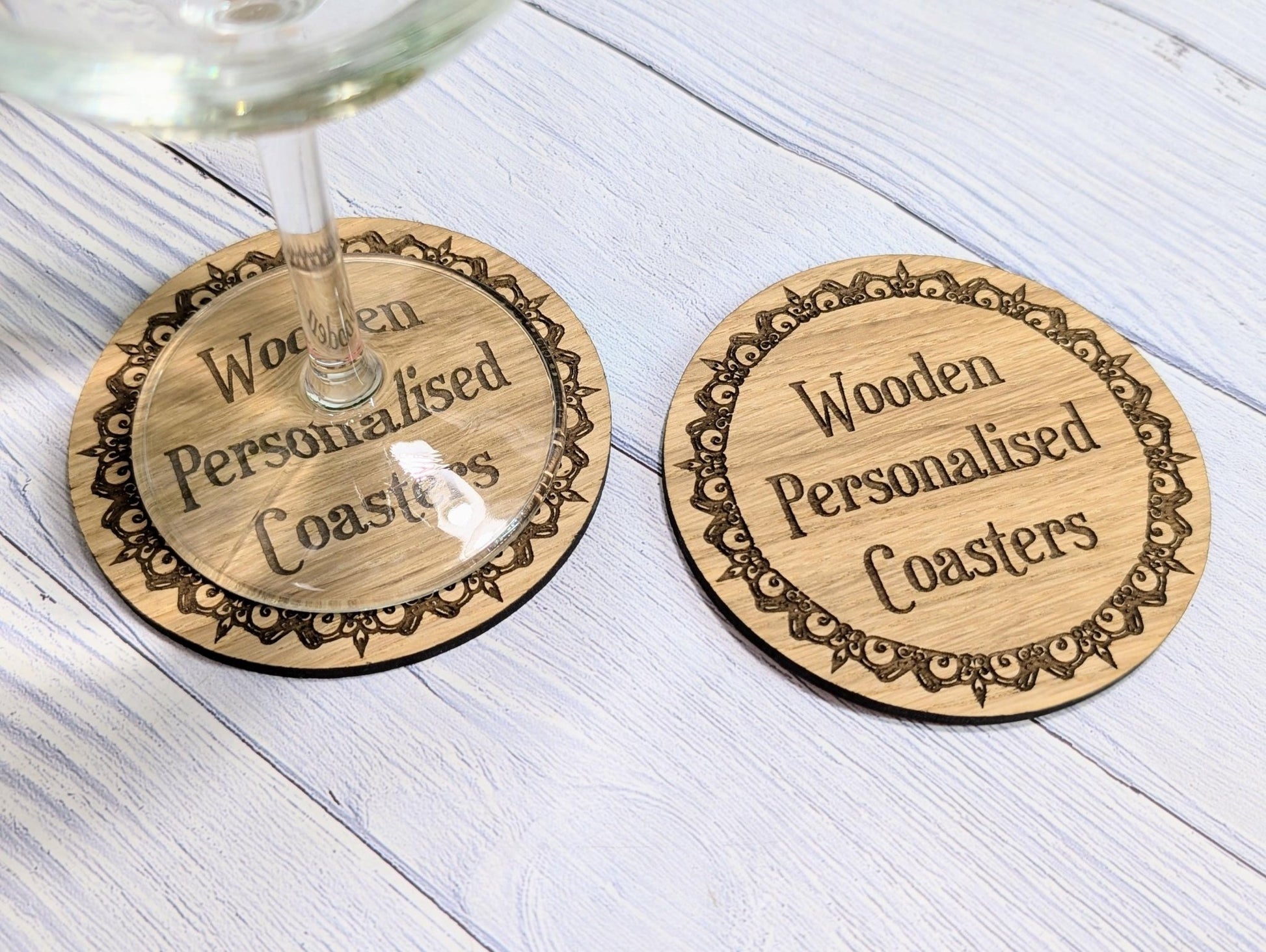 Engraved border coasters on table — personalised with custom text
