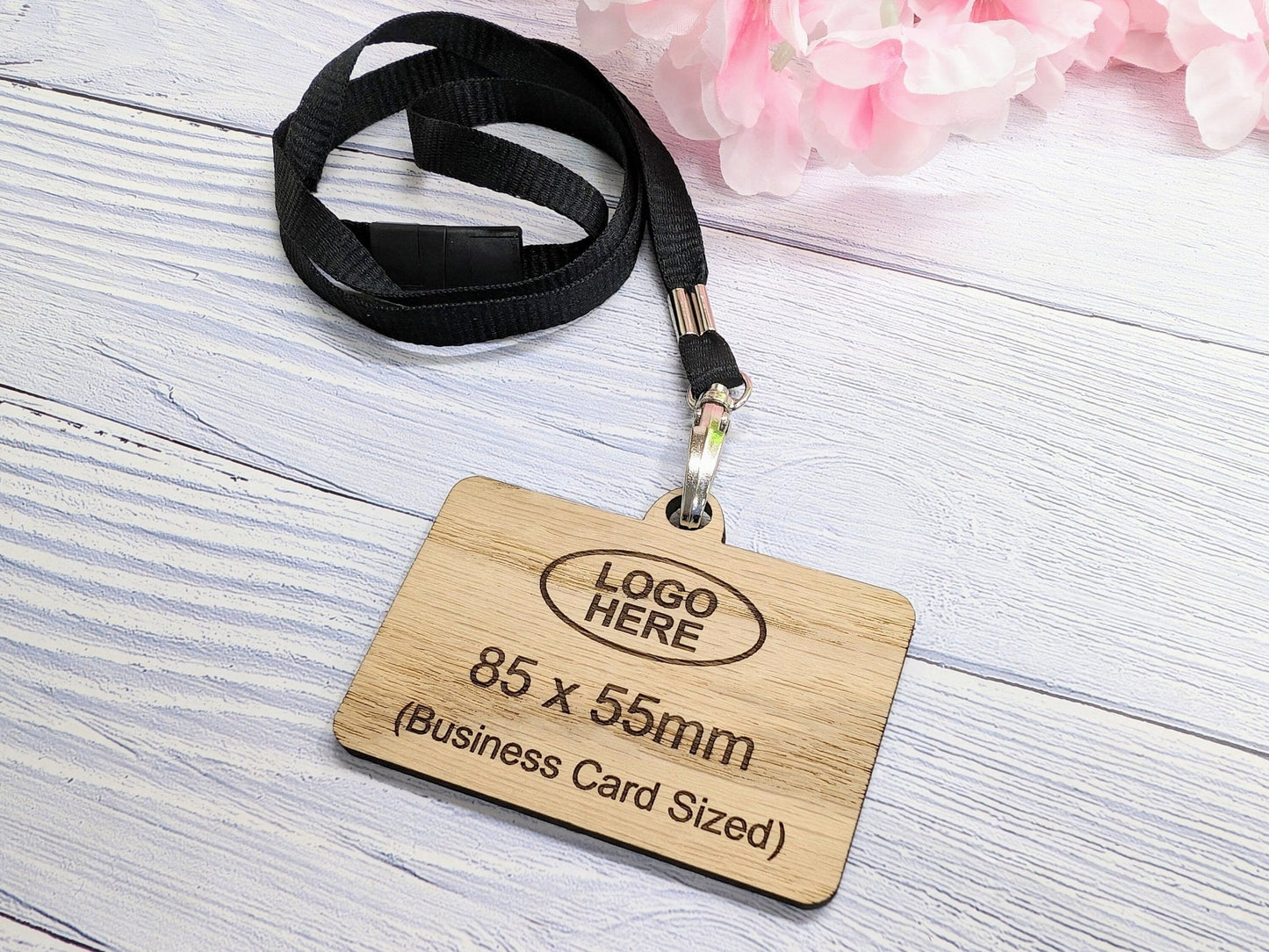 Custom name badges with lanyards close-up — logo and staff name engraved