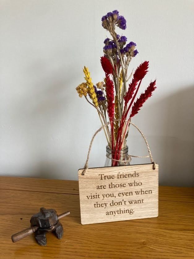 Personalised oak sign close-up showing engraved text detail