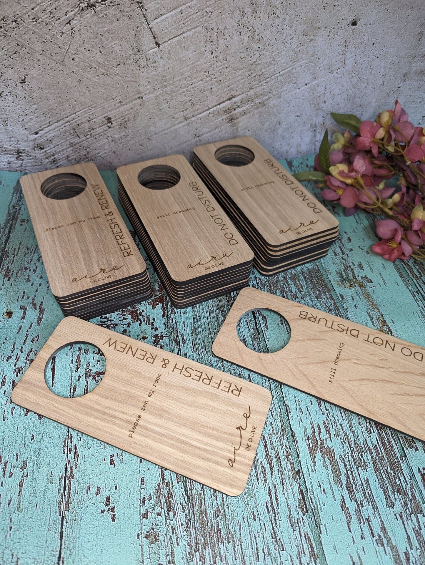 Hotel door hanger in use — hanging on hotel room door handle, oak veneer