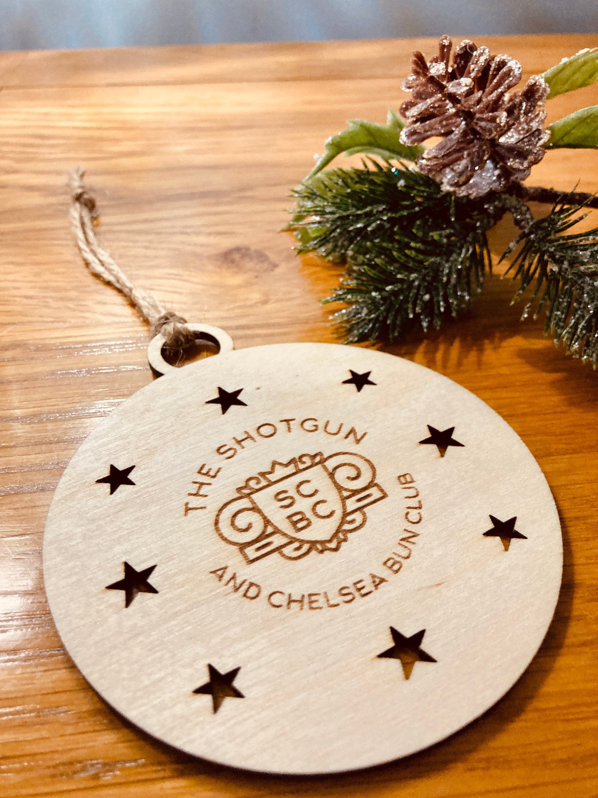 Personalised corporate Christmas baubles shown in bulk with various ribbon colours