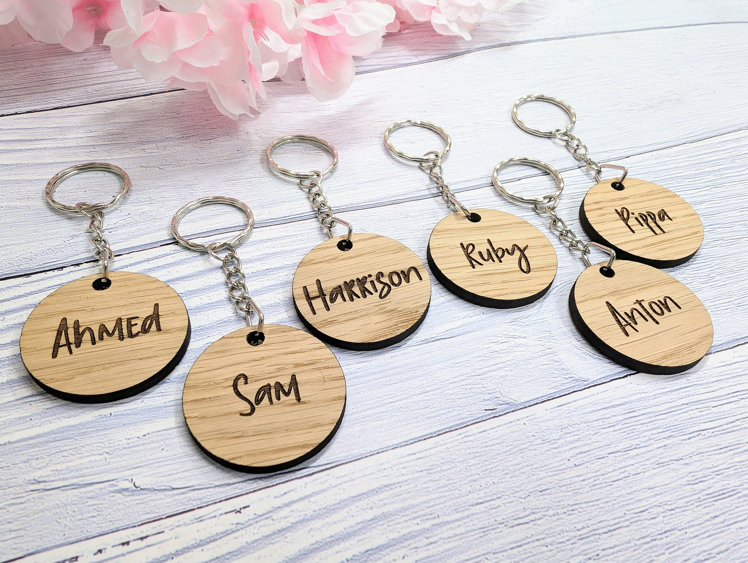 Personalised oak student keyrings engraved with individual names, gift from teacher