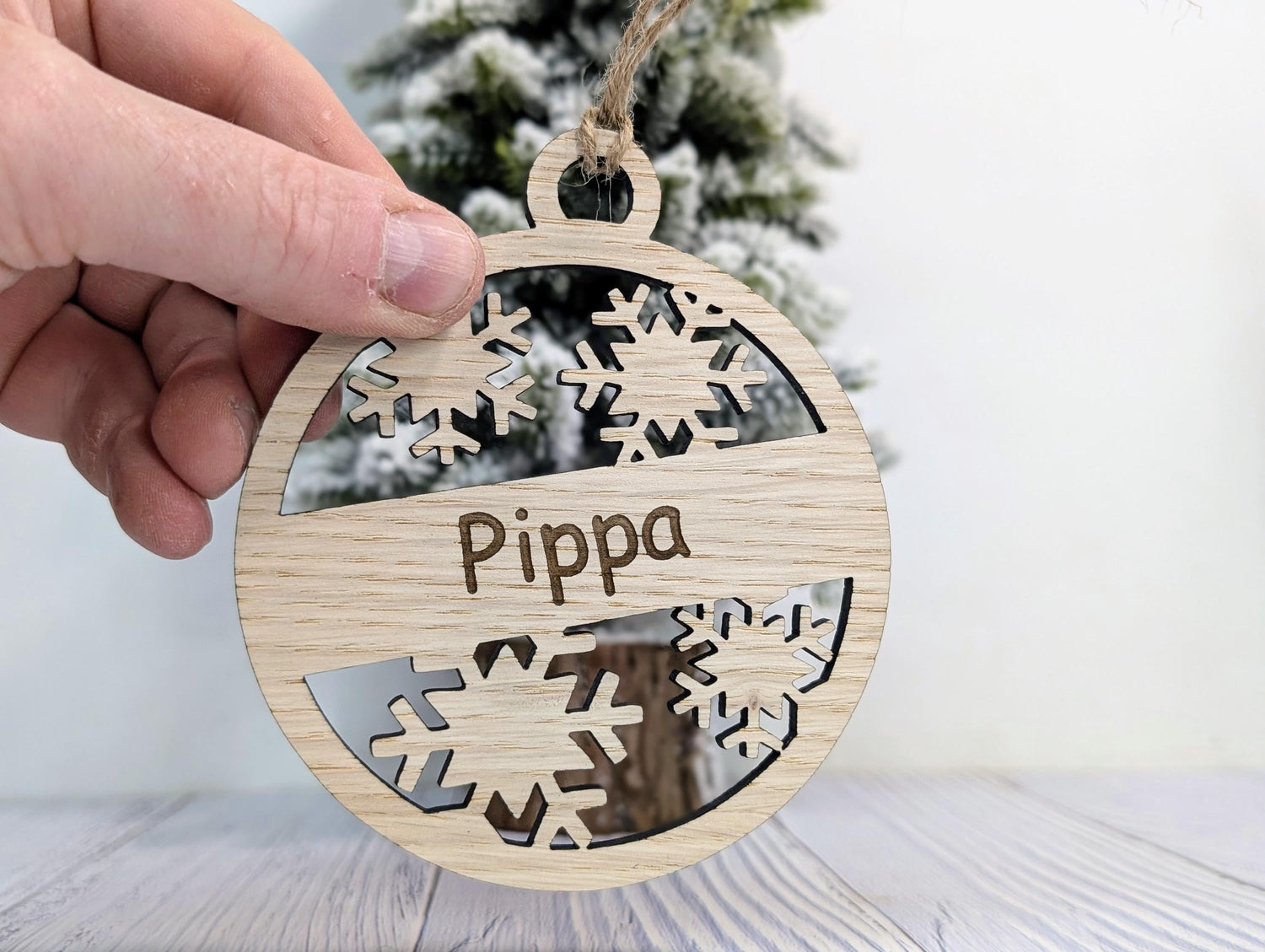 Personalised snowflake Christmas bauble — oak, name engraved, 10cm diameter