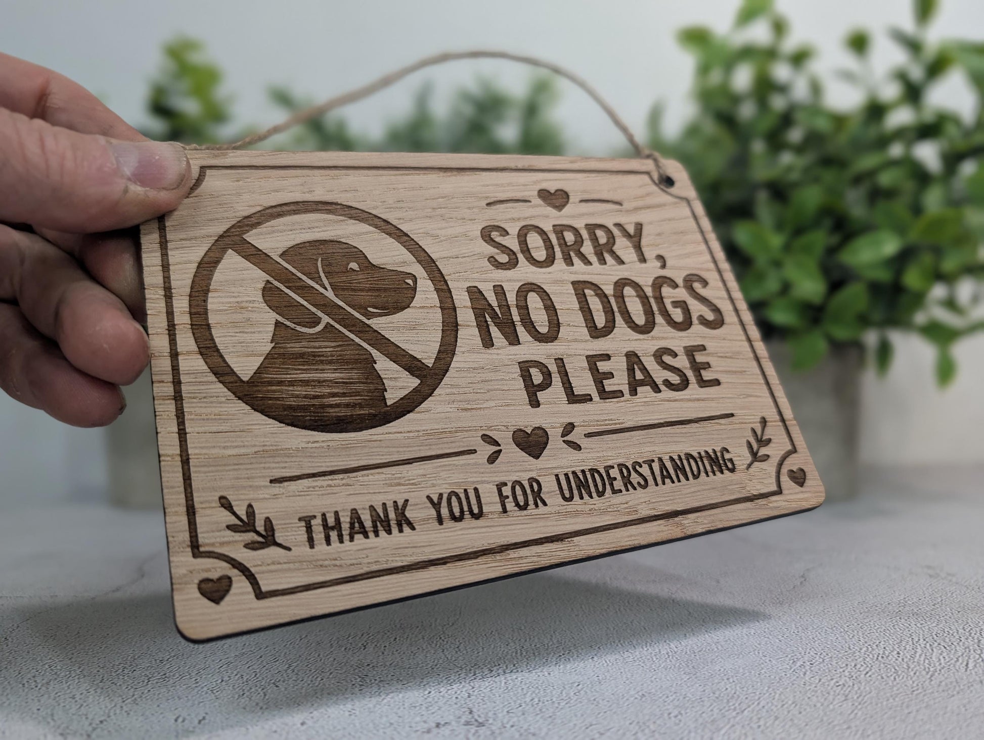 Sorry No Dogs Please oak veneer sign close-up detail