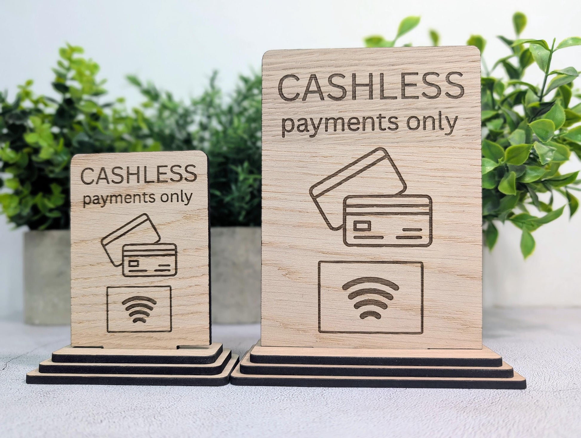 Modern framed cashless payments sign in oak veneer, standing on a restaurant or bar counter