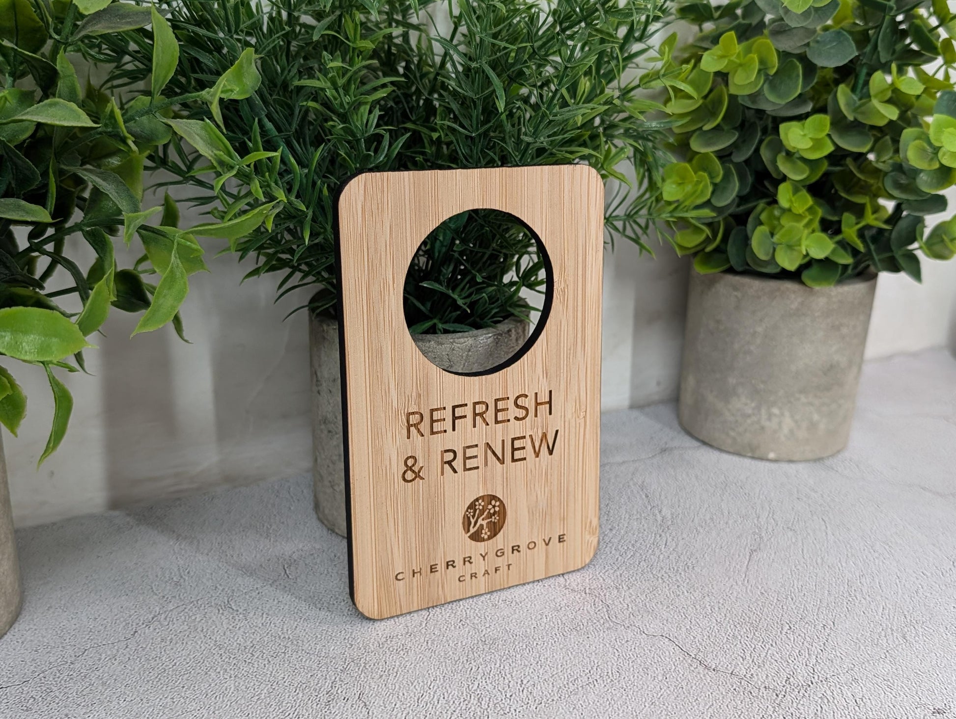 Reversible bamboo door hanger on a hotel guest room handle