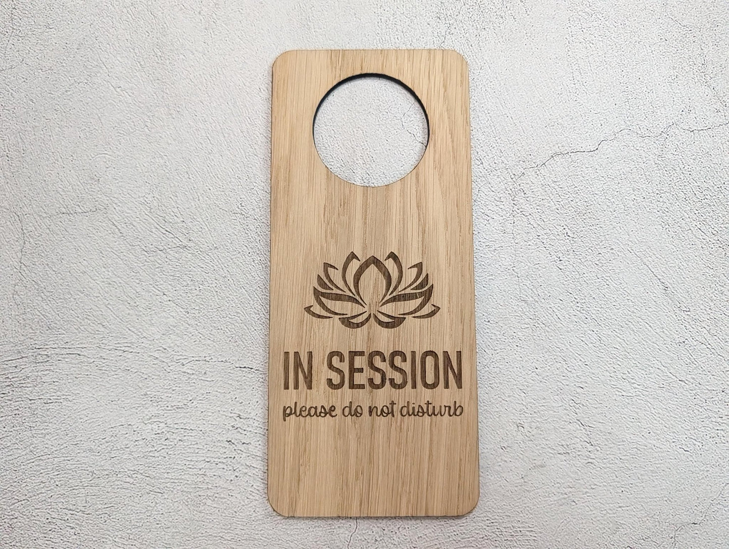 In Session oak door hanger in therapy room door setting — wellness studio