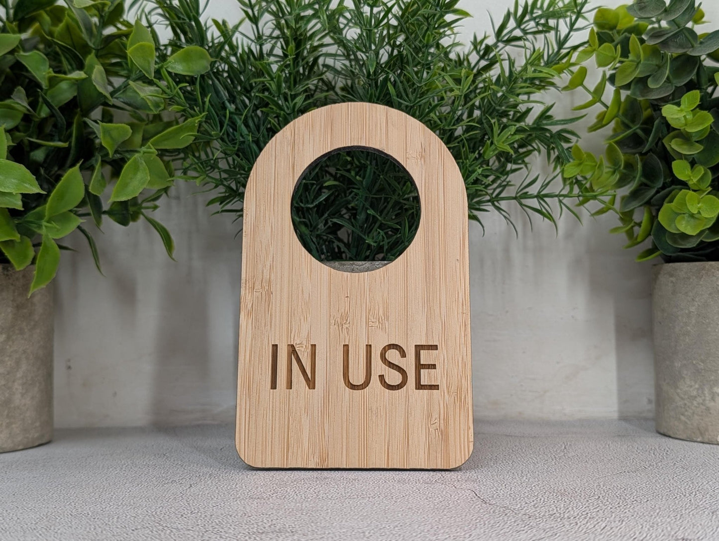 Laser-engraved In Use lettering on 5mm bamboo, grain detail