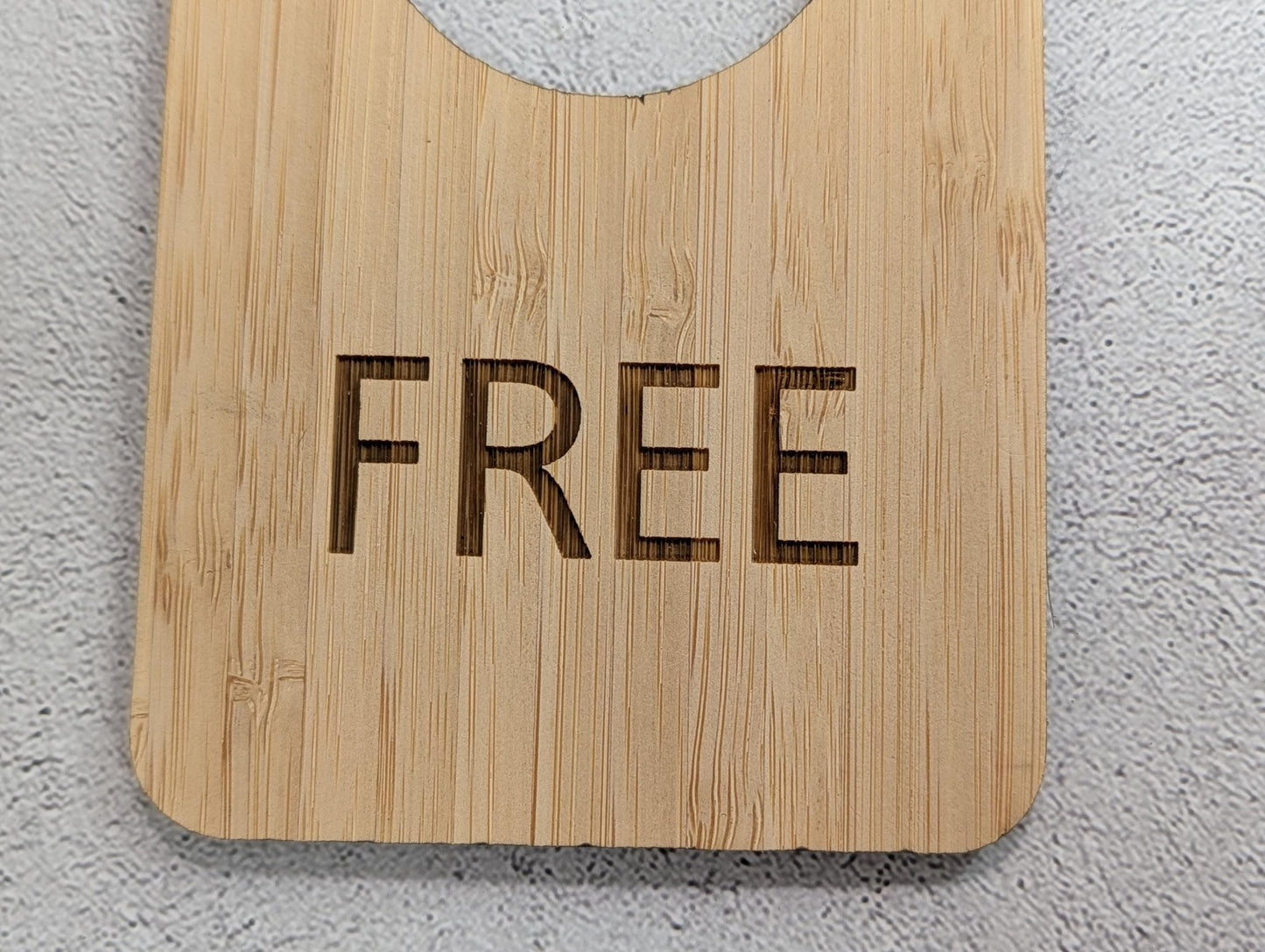 In Use / Free bamboo door hanger in a bathroom setting