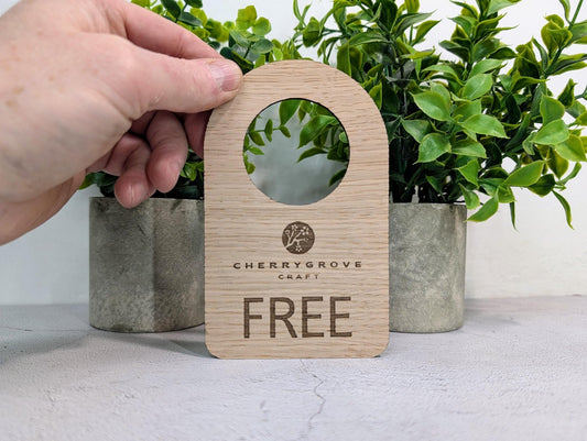 In Use / Free door hanger with custom logo — FSC-certified oak veneered MDF, 89x144mm