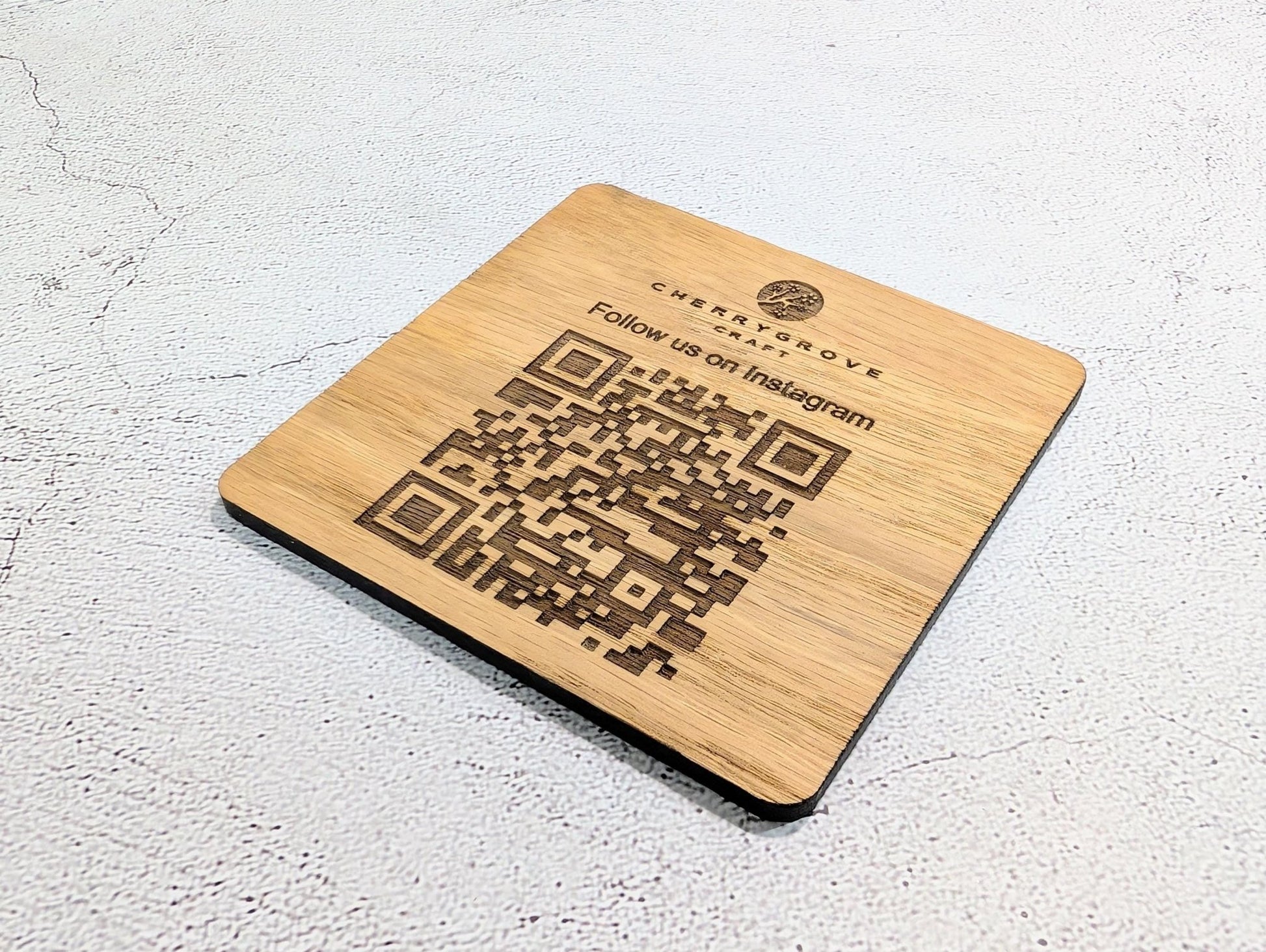 Instagram QR coaster showing logo and scan to follow text — 90x90mm square oak veneered MDF