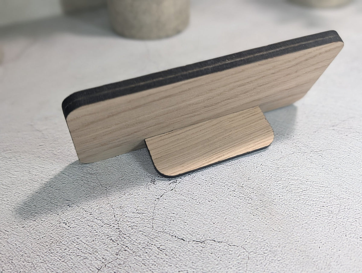 Back of the oak QR code stand at an angle, showing the tab stand pushed into its slot