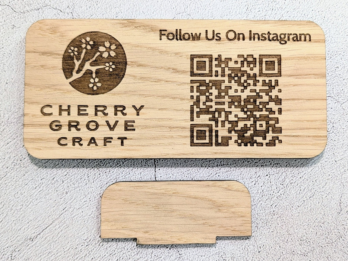 Instagram QR code stand engraved with a logo, "Follow Us On Instagram" and a QR code, laid flat above its tab stand