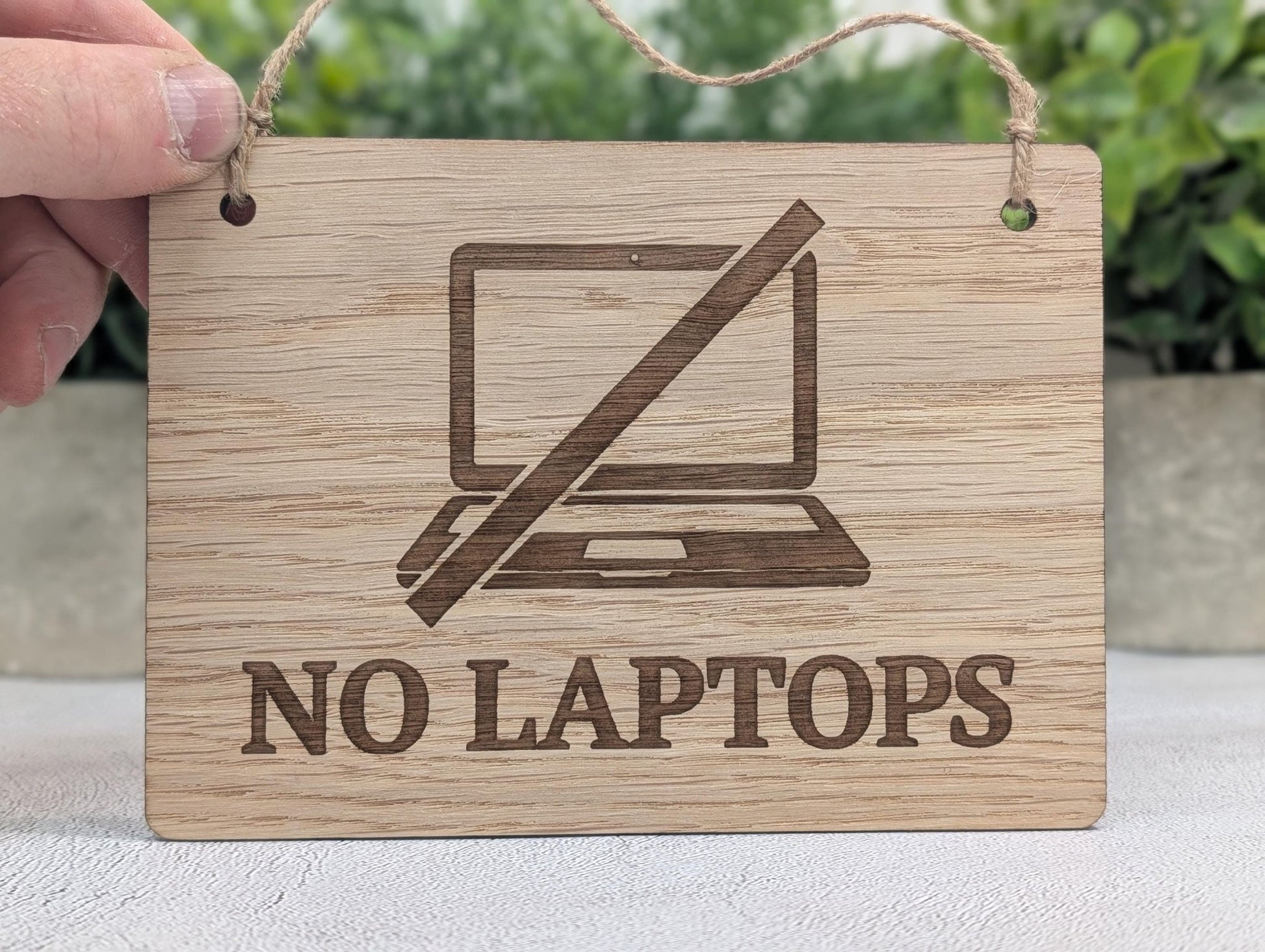 No laptops sign — oak veneered MDF, hung on café wall with jute string