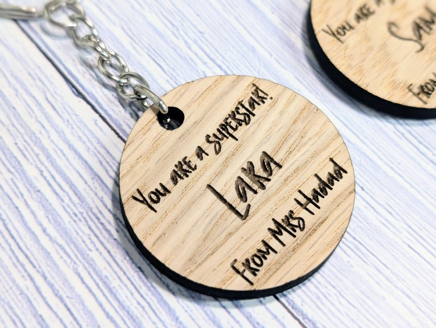 Superstar student keyring close-up — star shape and engraved name, oak