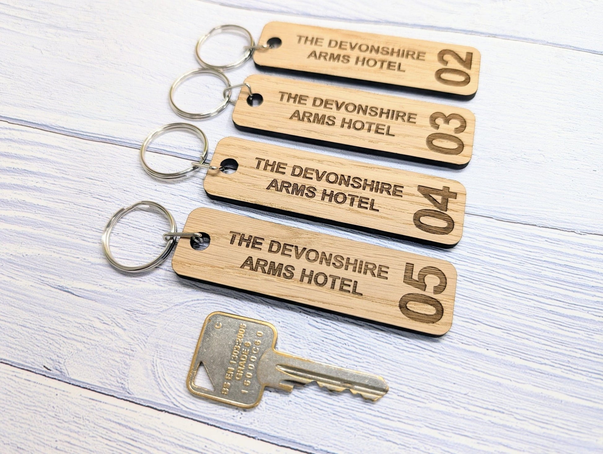 Hotel room keyring showing Danish oil finish — 90x25mm oak