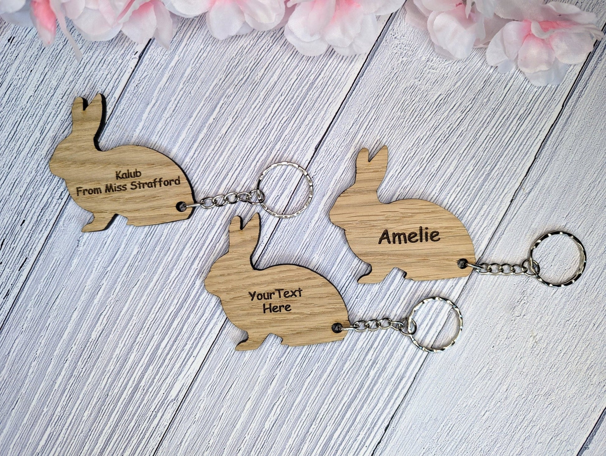 Oak rabbit keyring close-up — personalised name engraved below silhouette