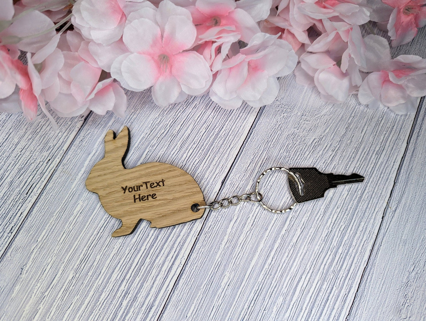 Personalised rabbit keyring on a set of keys — 60mm oak, custom text